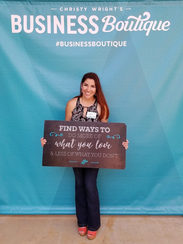 Coppelia Marie holds up an inspiring quote at Business Boutique