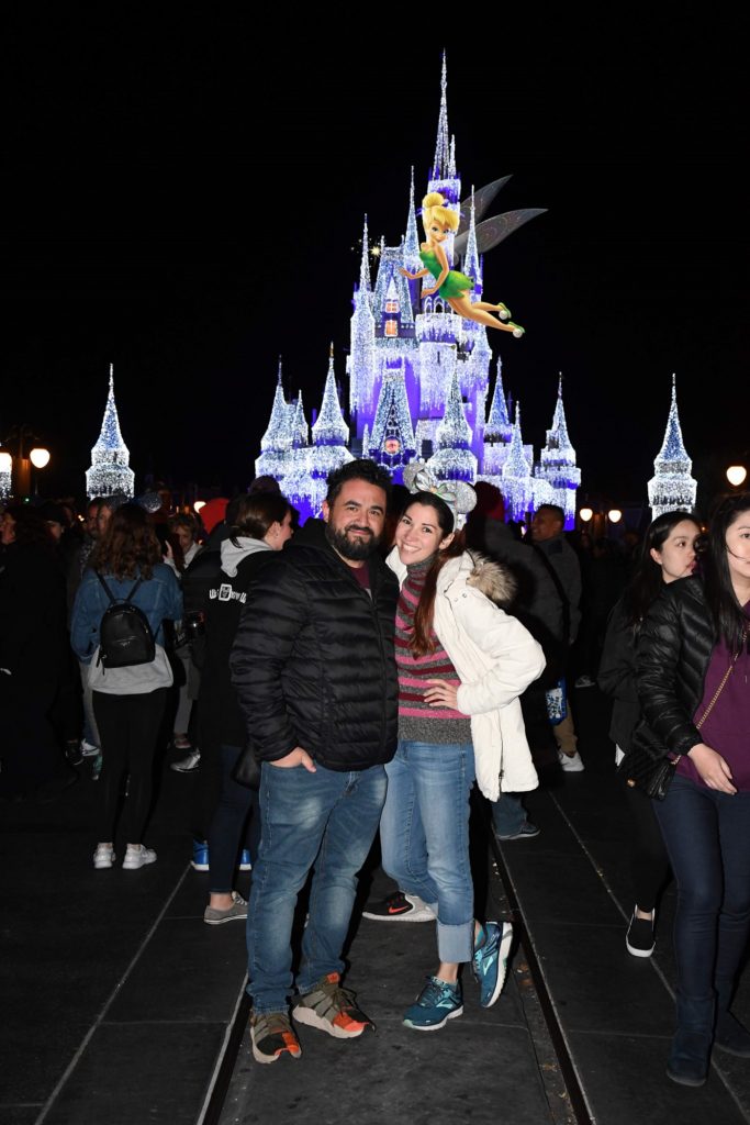 Couple in front of Cinderella's Castle at Disney's Magic Kingdom with Tinkerbell