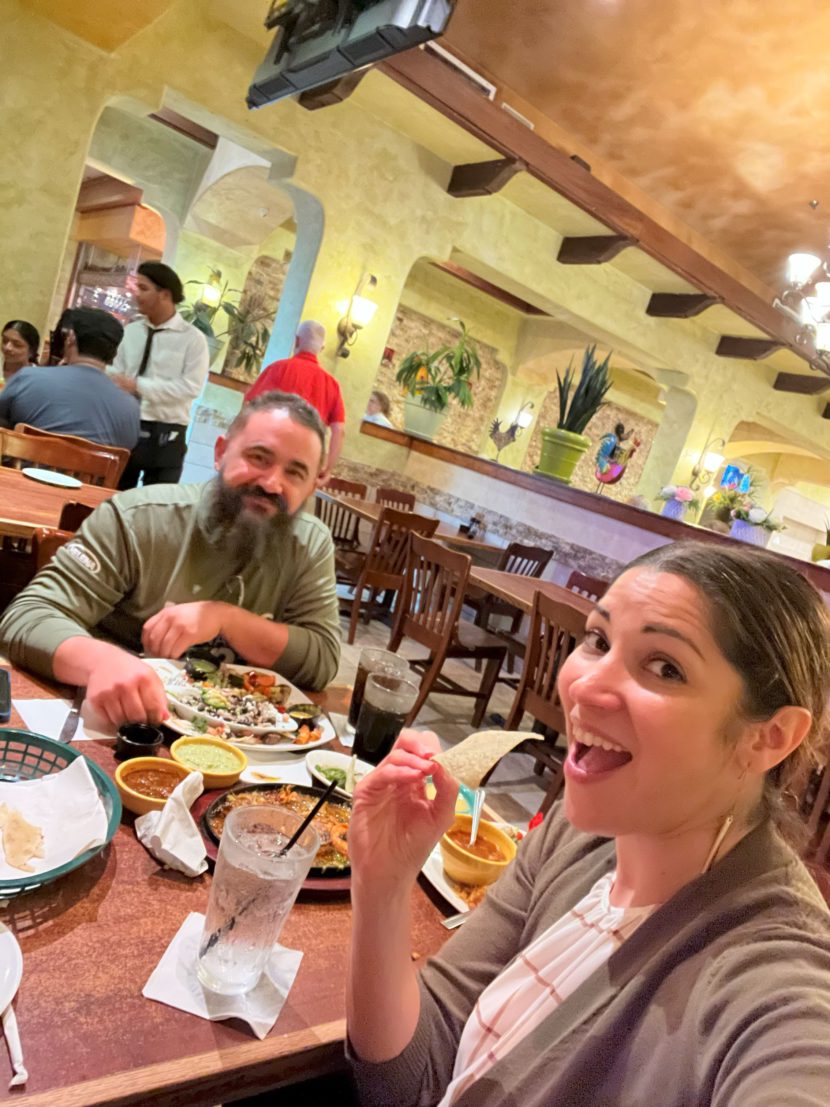 Smiling latino husband and wife enjoy date night at a mexican restaurant